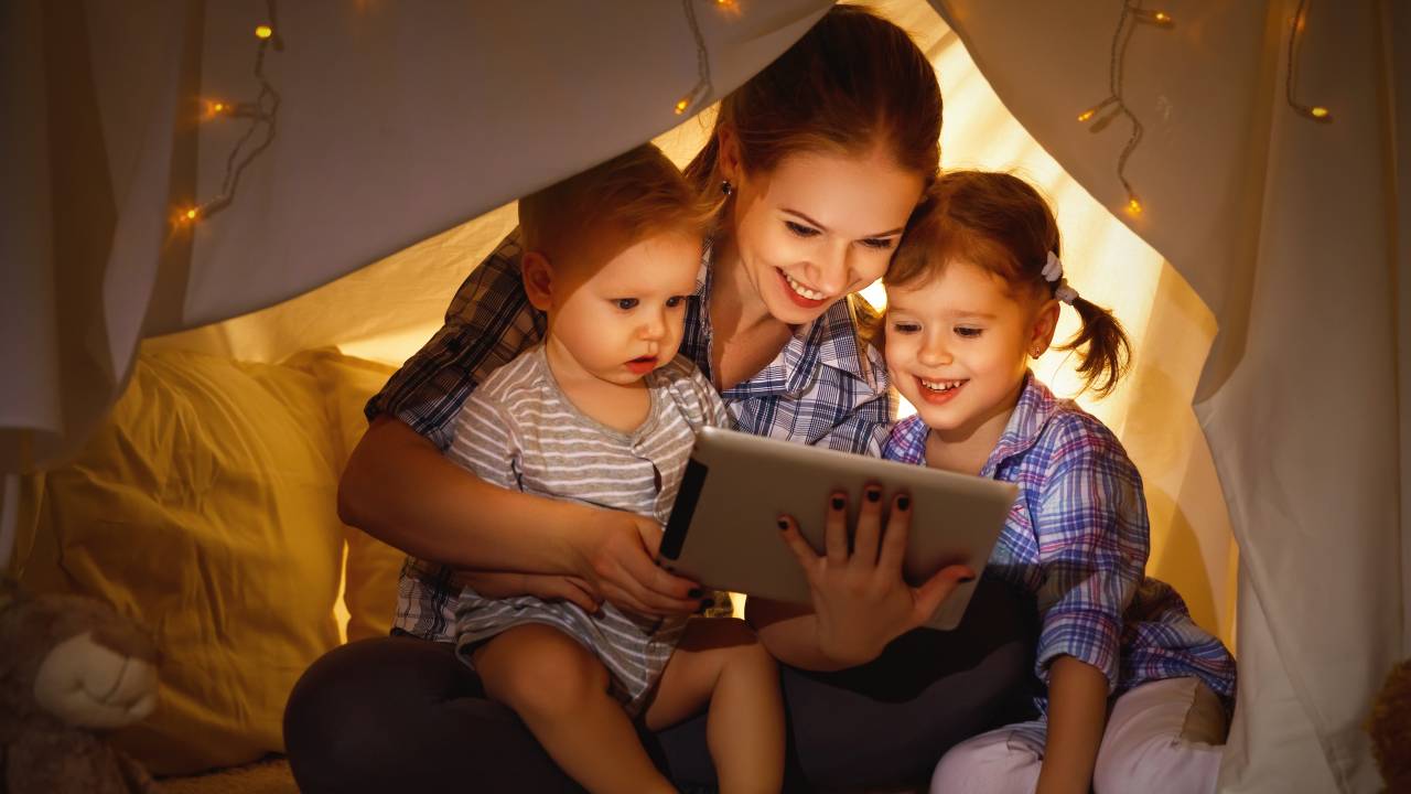 Mãe e filhas assistindo tablet
